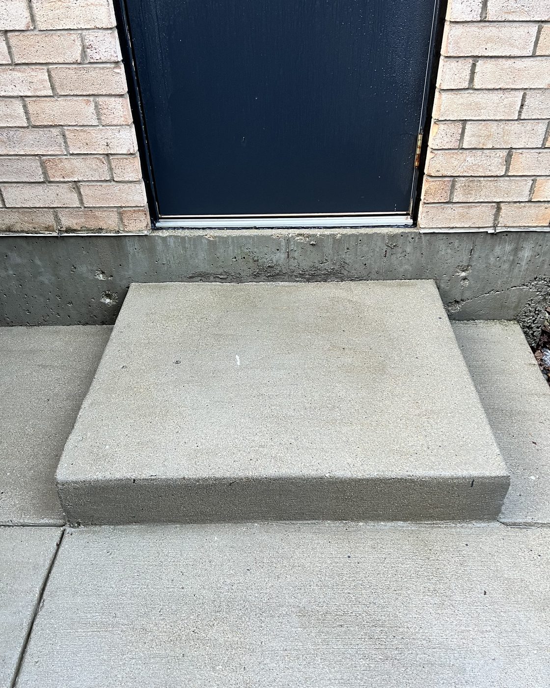 Clean concrete entry stoop after power washing